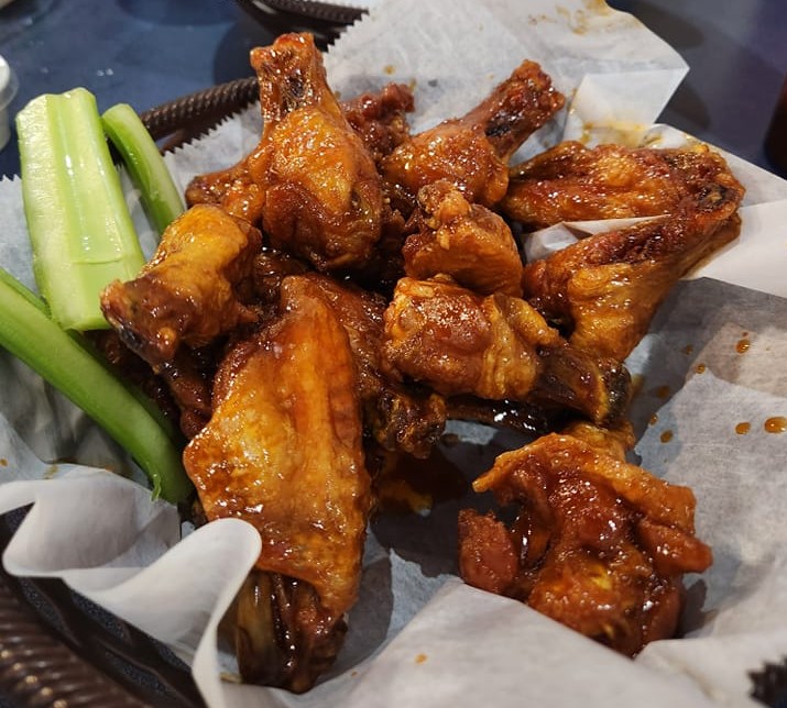 Basket of tasty traditional bone-in wings with celery